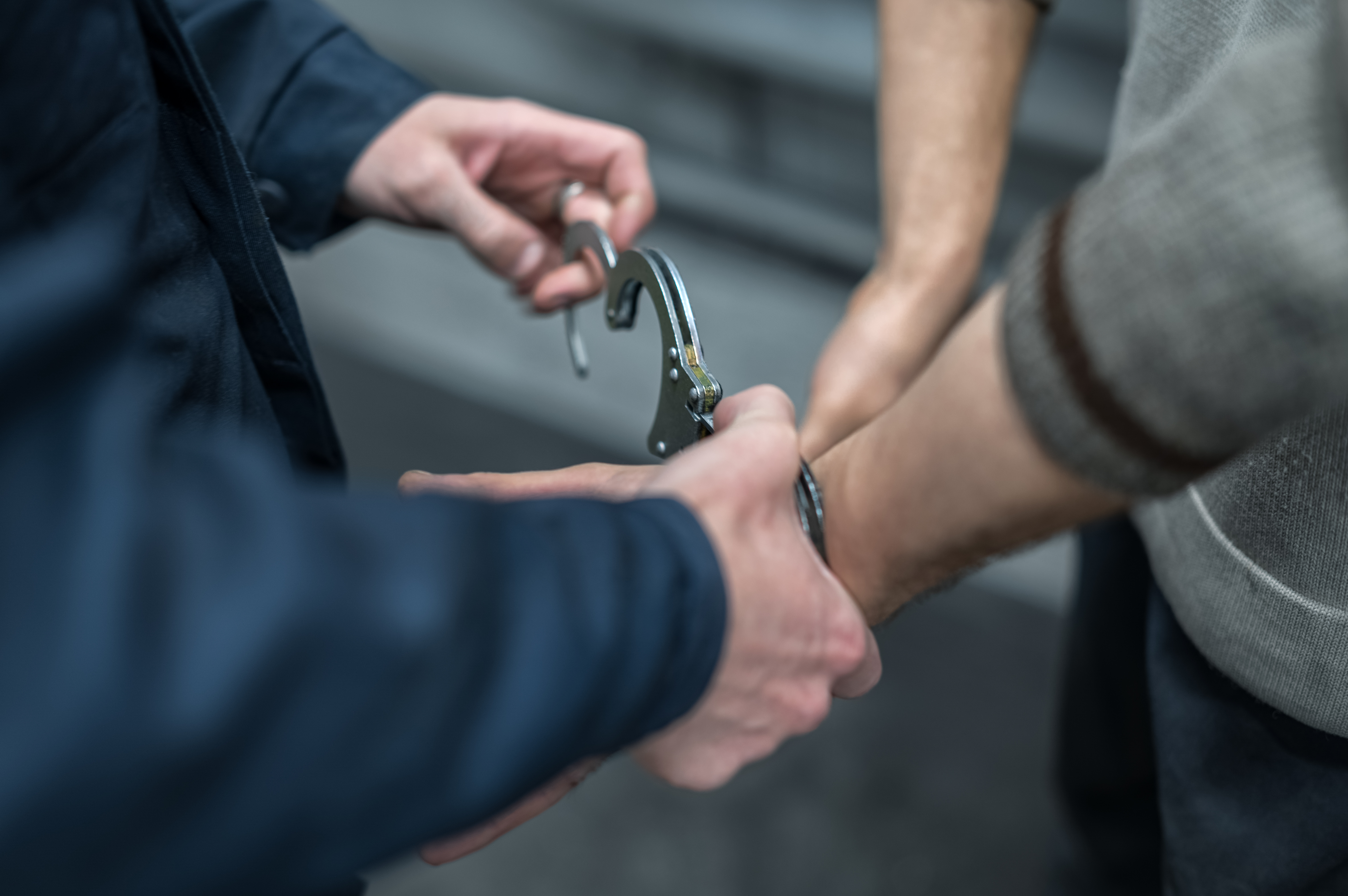 A handcuffed person in need of a criminal defense attorney in Utah like Branson West Law.