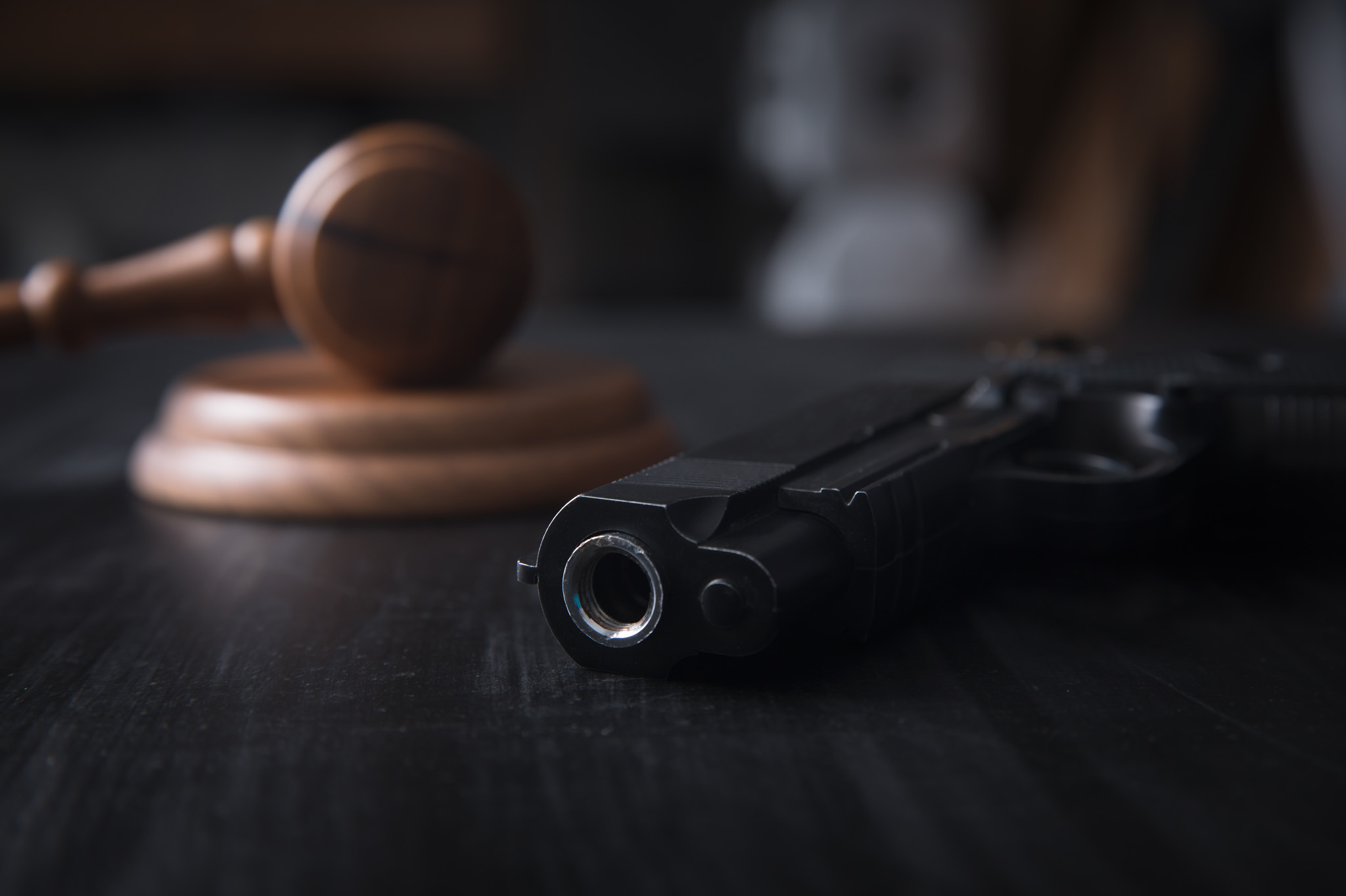 An image of a gun and gavel - domestic violence gun laws in Utah can be complicated so contact Branson West Law today if you need assistance.